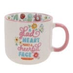A Glad Heart Makes a Cheerful Face Ceramic Mug